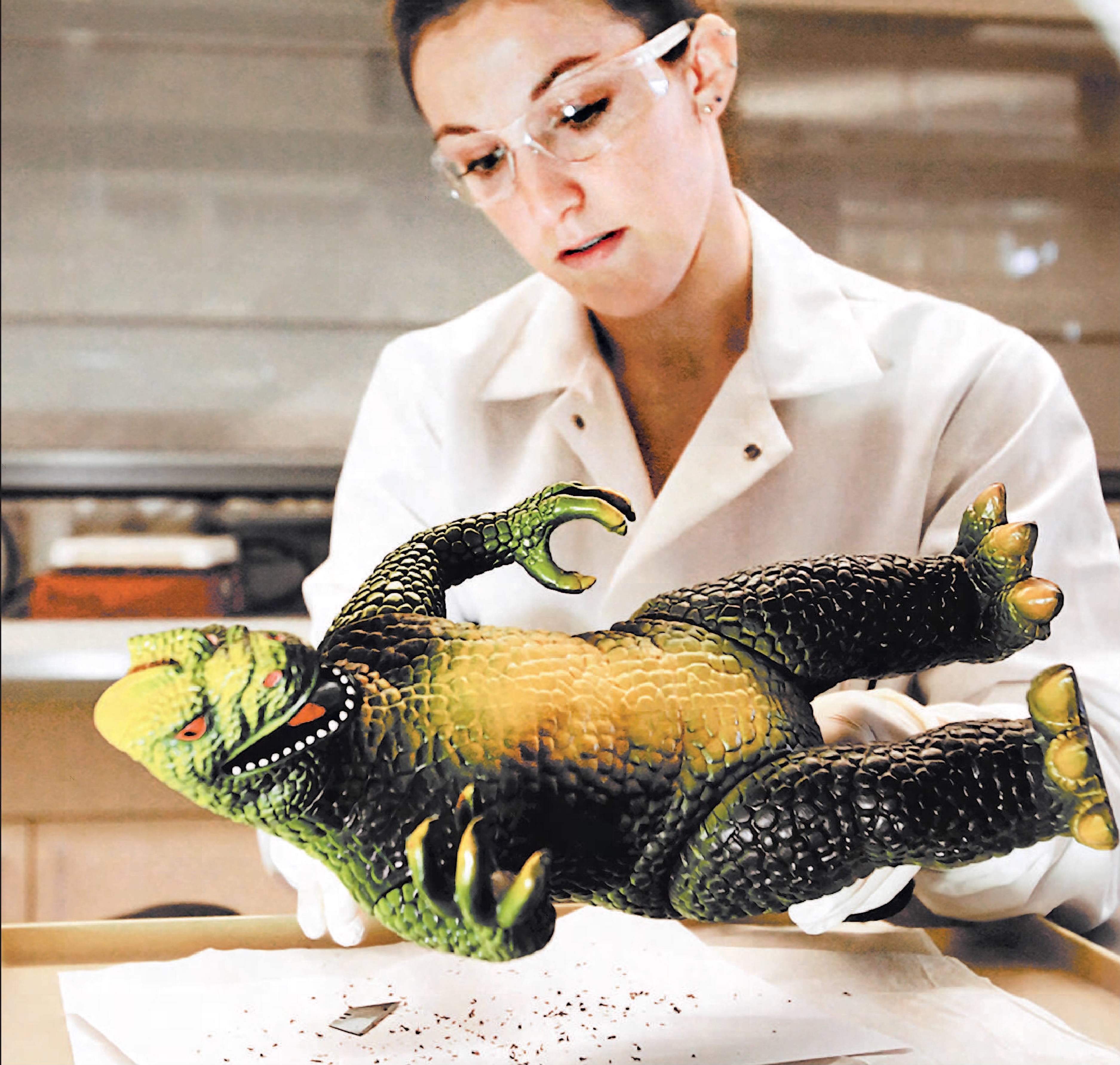 woman holding toy dinosaur